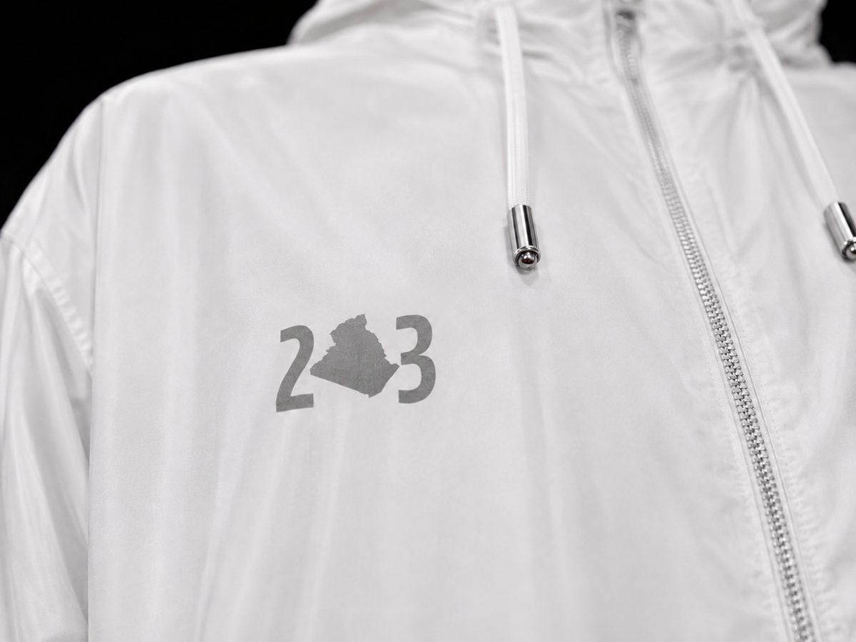 Indicatif 213 avec carte de l'Algérie sur veste blanche, détail